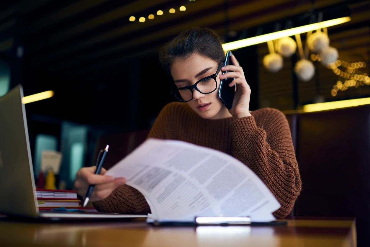 phone call with laptop and paperwork